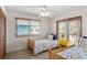 Charming bedroom furnished with twin beds, a bright yellow side table, and access to an outdoor balcony at 6956 Turtlemound Rd, New Smyrna Beach, FL 32169