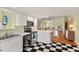 Open kitchen showcasing stainless appliances, white cabinetry, and a seamless transition to the dining and living areas at 6956 Turtlemound Rd, New Smyrna Beach, FL 32169