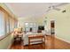 Inviting living room with hardwood floors, white couches and access to a balcony at 6956 Turtlemound Rd, New Smyrna Beach, FL 32169