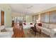 Cozy living room with hardwood floors connected to the kitchen and dining area at 6956 Turtlemound Rd, New Smyrna Beach, FL 32169