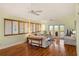 Inviting living room with hardwood floors, white couches and access to a balcony at 6956 Turtlemound Rd, New Smyrna Beach, FL 32169