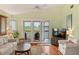 Cozy living room with natural light and access to an outdoor balcony at 6956 Turtlemound Rd, New Smyrna Beach, FL 32169