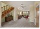 Spacious living room with stairs, bar area, comfortable seating, and seamless flow to the outdoors at 6956 Turtlemound Rd, New Smyrna Beach, FL 32169