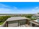 Rooftop deck view overlooking a waterfront with gorgeous trees at 6956 Turtlemound Rd, New Smyrna Beach, FL 32169