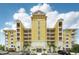 Stunning exterior showcasing the architectural design with bright yellows and towering facade at 7 Riverwalk Dr # 305, New Smyrna Beach, FL 32169
