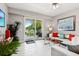 Comfortable living room with a balcony view of lush greenery and stylish decor at 7 Riverwalk Dr # 305, New Smyrna Beach, FL 32169