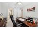 Comfortable office with a wooden desk, and nearby bathroom at 7 Riverwalk Dr # 305, New Smyrna Beach, FL 32169