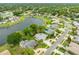 Scenic aerial view of a home nestled by a tranquil lake in a lush, green neighborhood at 757 Hunt Club Trl, Port Orange, FL 32127