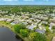 Aerial view of home in a lush, green neighborhood with a nearby lake at 757 Hunt Club Trl, Port Orange, FL 32127
