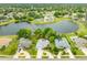 Beautiful aerial view of a home with lush landscaping and a tranquil lake in a desirable neighborhood at 757 Hunt Club Trl, Port Orange, FL 32127