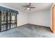 Bedroom featuring sliding glass doors, a ceiling fan, and blue carpet at 757 Hunt Club Trl, Port Orange, FL 32127