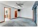 Bright bedroom features a ceiling fan, neutral walls and carpet, with access to bathroom at 757 Hunt Club Trl, Port Orange, FL 32127