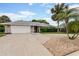 Charming single-story home boasting a wide driveway, two-car garage, and lush tropical landscaping at 757 Hunt Club Trl, Port Orange, FL 32127