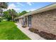 Side view of brick home shows landscaped yard, central air, secure entrance and walkway at 757 Hunt Club Trl, Port Orange, FL 32127
