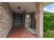 Inviting brick front porch with decorative ironwork, adding character to the home's entrance at 757 Hunt Club Trl, Port Orange, FL 32127