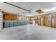 Spacious garage with utility sink, cabinets, work bench, peg board, and coated concrete floors at 757 Hunt Club Trl, Port Orange, FL 32127