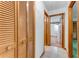 Hallway with wood-look storage and view into adjacent rooms and ceramic tile floors at 757 Hunt Club Trl, Port Orange, FL 32127