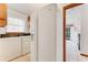 Functional laundry area featuring appliances, oak cabinets, and tile floors at 757 Hunt Club Trl, Port Orange, FL 32127