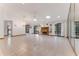 Large living room with tile floors, fireplace, ceiling fan, and mirrored wall with access to the yard at 757 Hunt Club Trl, Port Orange, FL 32127