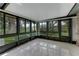 Sunroom with ceramic tile floor and walls of windows with backyard views at 757 Hunt Club Trl, Port Orange, FL 32127