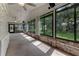 Sunroom with full walls of windows looking out onto the property, brick accents, and ceiling fans at 757 Hunt Club Trl, Port Orange, FL 32127