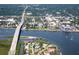 Scenic aerial view of coastal town featuring a bridge, waterfront homes, and boat docks along the water at 8 Richmond Dr, New Smyrna Beach, FL 32169