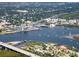 Breathtaking aerial view featuring a waterfront community, private docks, and boats near a coastal bridge at 8 Richmond Dr, New Smyrna Beach, FL 32169