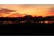 Picturesque waterfront view at sunset, showcasing a pier leading to structures across calm waters at 8 Richmond Dr, New Smyrna Beach, FL 32169