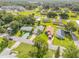 Neighborhood aerial view featuring houses with lush green lawns and mature trees at 805 Spruce St, New Smyrna Beach, FL 32168