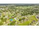 Serene aerial shot of a residential neighborhood with a golf course in the background surrounded by trees at 805 Spruce St, New Smyrna Beach, FL 32168