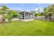 Expansive backyard features a screened-in porch, offering an ideal space for outdoor living at 805 Spruce St, New Smyrna Beach, FL 32168