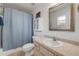Bathroom featuring a shower-tub combo, a large mirror, and ample counter space at 805 Spruce St, New Smyrna Beach, FL 32168