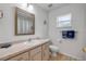 Bathroom featuring a shower-tub combo, a large mirror, and ample counter space at 805 Spruce St, New Smyrna Beach, FL 32168