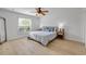 Bright bedroom featuring wood-look floors, a ceiling fan, and sunny window views at 805 Spruce St, New Smyrna Beach, FL 32168
