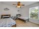 Bedroom featuring wood-look floors, two twin beds and a sunny window at 805 Spruce St, New Smyrna Beach, FL 32168
