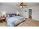 Bright bedroom featuring wood-look floors, a ceiling fan, and a walk in closet at 805 Spruce St, New Smyrna Beach, FL 32168