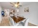 Bright dining area offers a stylish wood table, room for eight and open access to the kitchen at 805 Spruce St, New Smyrna Beach, FL 32168