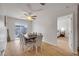Bright dining room features wood-style flooring, contemporary table with seating for eight, and sliding glass doors at 805 Spruce St, New Smyrna Beach, FL 32168