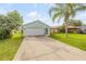Charming single Gathering home featuring an attached two car garage, a well maintained lawn and lush tropical landscaping at 805 Spruce St, New Smyrna Beach, FL 32168