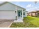 Well-maintained home featuring a quaint front porch with elegant column details and white trim at 805 Spruce St, New Smyrna Beach, FL 32168