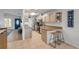 Cozy kitchen featuring tile floors, breakfast bar seating, and views of the front of the home at 805 Spruce St, New Smyrna Beach, FL 32168