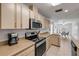 Updated kitchen with tan counters, stainless steel appliances and stylish cabinetry at 805 Spruce St, New Smyrna Beach, FL 32168