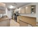 Updated kitchen with tan counters, tile flooring, stainless appliances and ample cabinet space at 805 Spruce St, New Smyrna Beach, FL 32168