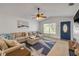 Bright living room with high ceilings, hardwood floors, a large sectional, and lots of natural light at 805 Spruce St, New Smyrna Beach, FL 32168