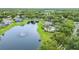 Aerial view of a community with a pond, fountain, pool, and lush greenery at 850 Wingate Trl, Port Orange, FL 32128