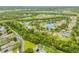 An aerial view showcasing a well-maintained neighborhood with mature trees and community lakes at 850 Wingate Trl, Port Orange, FL 32128
