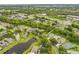 An aerial view of a neighborhood featuring mature trees, a lake, and well-maintained homes at 850 Wingate Trl, Port Orange, FL 32128