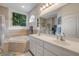 A spacious bathroom with double sinks, a soaking tub, and a separate glass enclosed shower at 850 Wingate Trl, Port Orange, FL 32128