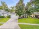 Charming single-story home with a well-maintained lawn, beautiful trees, and a two-car garage at 850 Wingate Trl, Port Orange, FL 32128