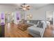 Spacious living room with hardwood floors, a ceiling fan, and a view of the front entryway at 850 Wingate Trl, Port Orange, FL 32128
